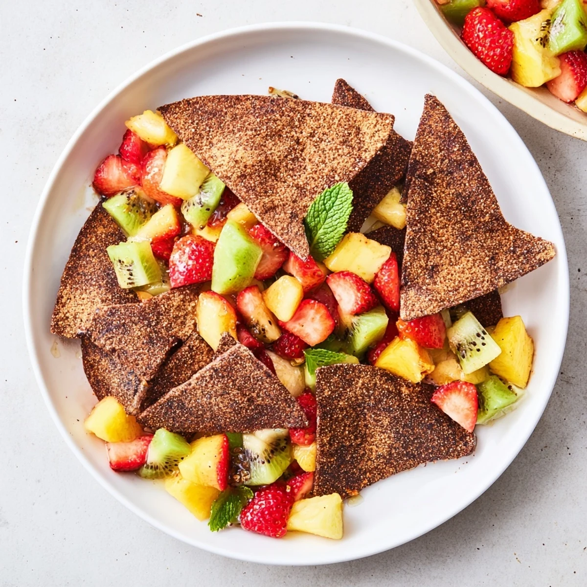 Crispy chocolate tortilla chips paired with refreshing fruit salsa, perfect for dessert.