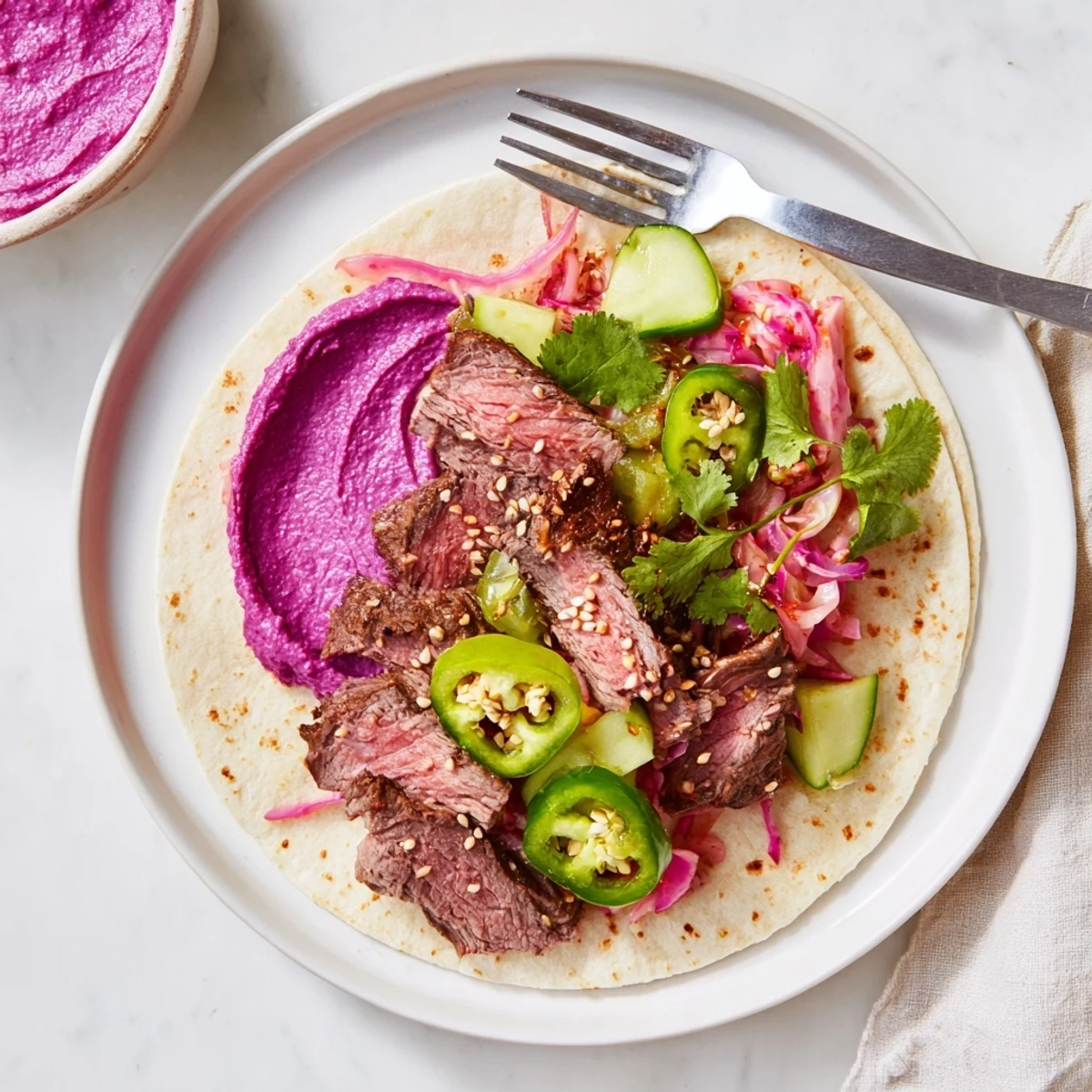 Flavorful Global Street-Food Fusion Bowls garnished with fresh veggies, ube crema, and tender meat.  