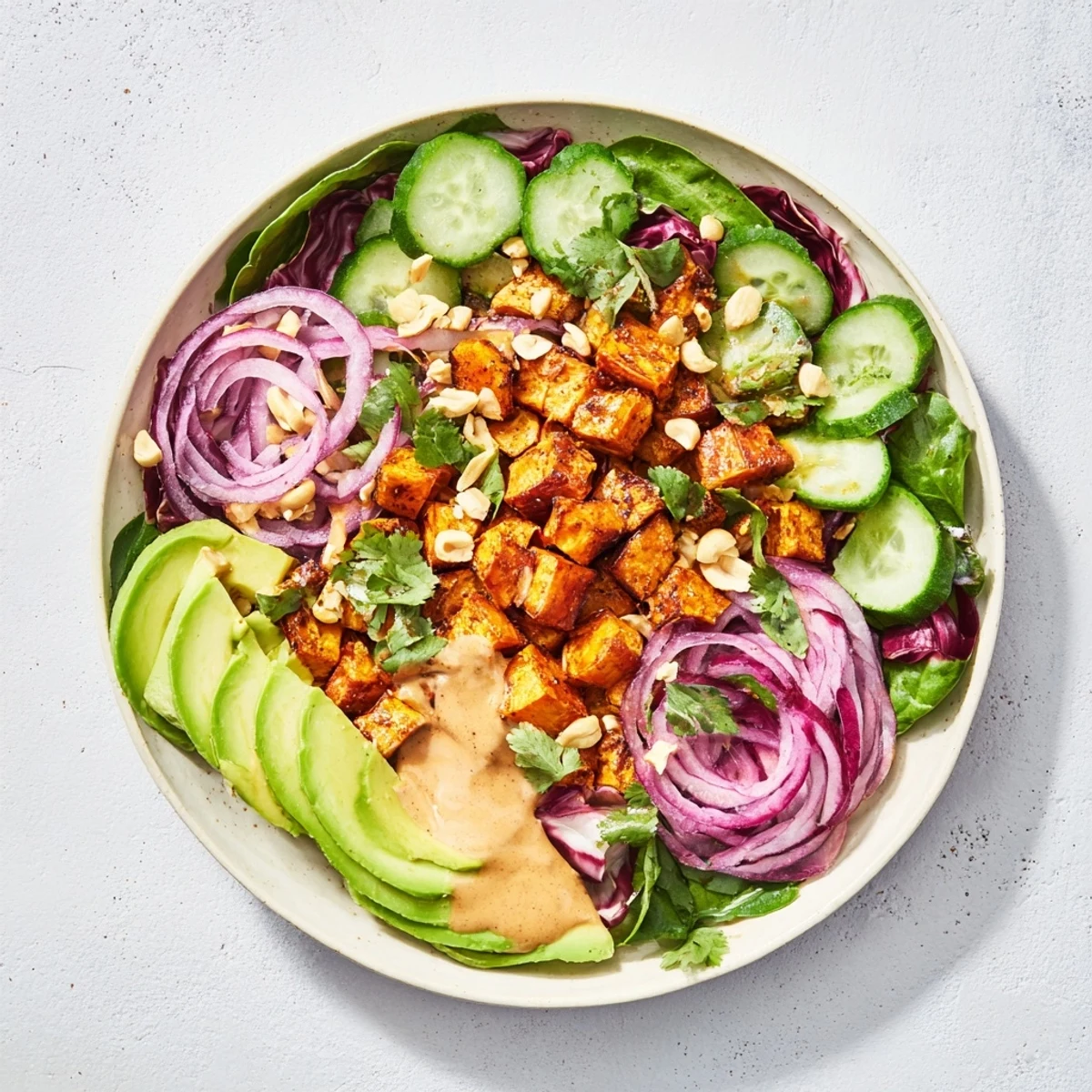 Vibrant Spiced Peanut Sweet Potato & Radicchio Salad Bowl, featuring roasted sweet potatoes and a creamy peanut dressing.