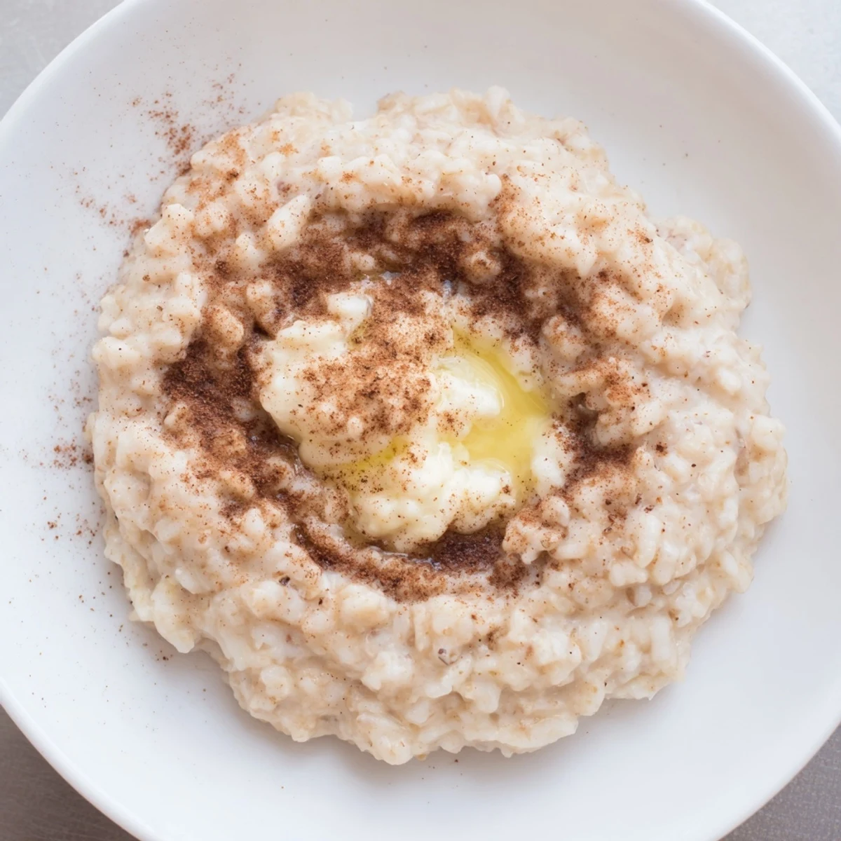 A comforting bowl of rice pudding made from leftover rice, subtly sweet and flavorful.