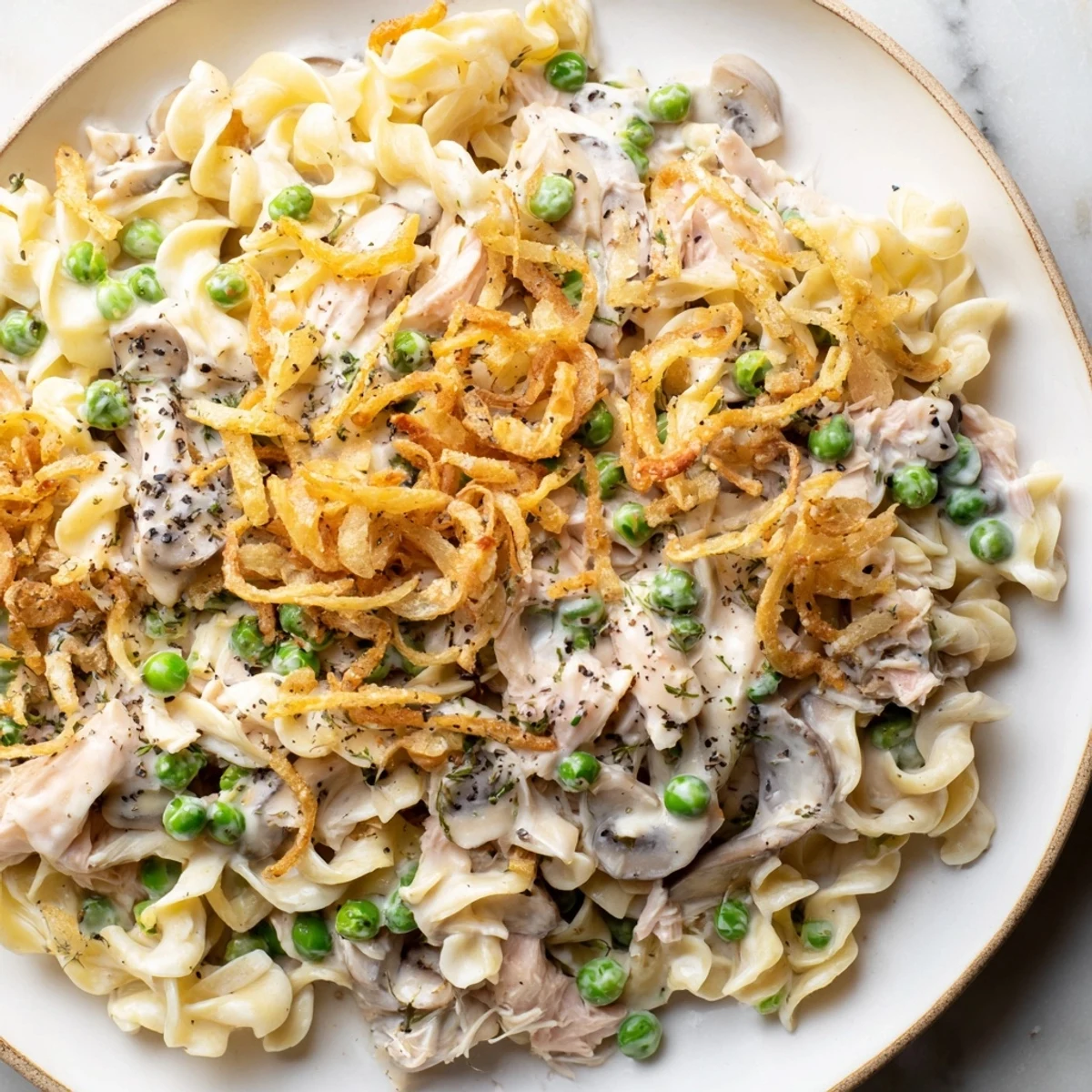 Homemade Tuna Noodle Casserole with a golden crust, bubbly inside, perfect for a cozy supper.