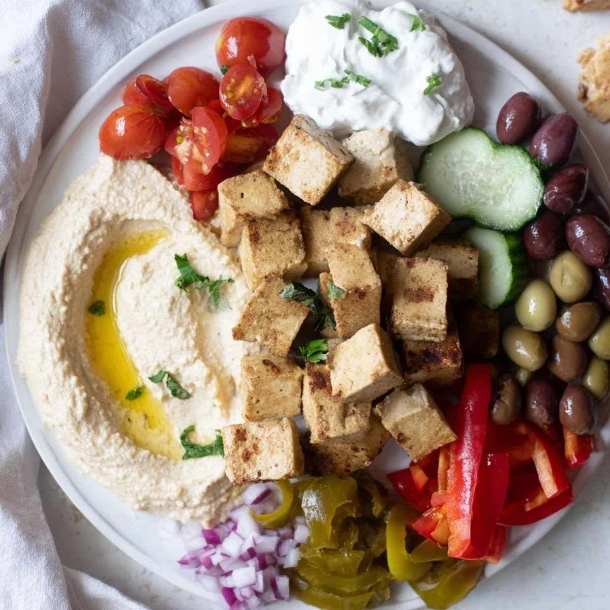 A delicious Mediterranean Mezza Platter, showcasing creamy dips and colorful vegetables, perfect for an appetizer.