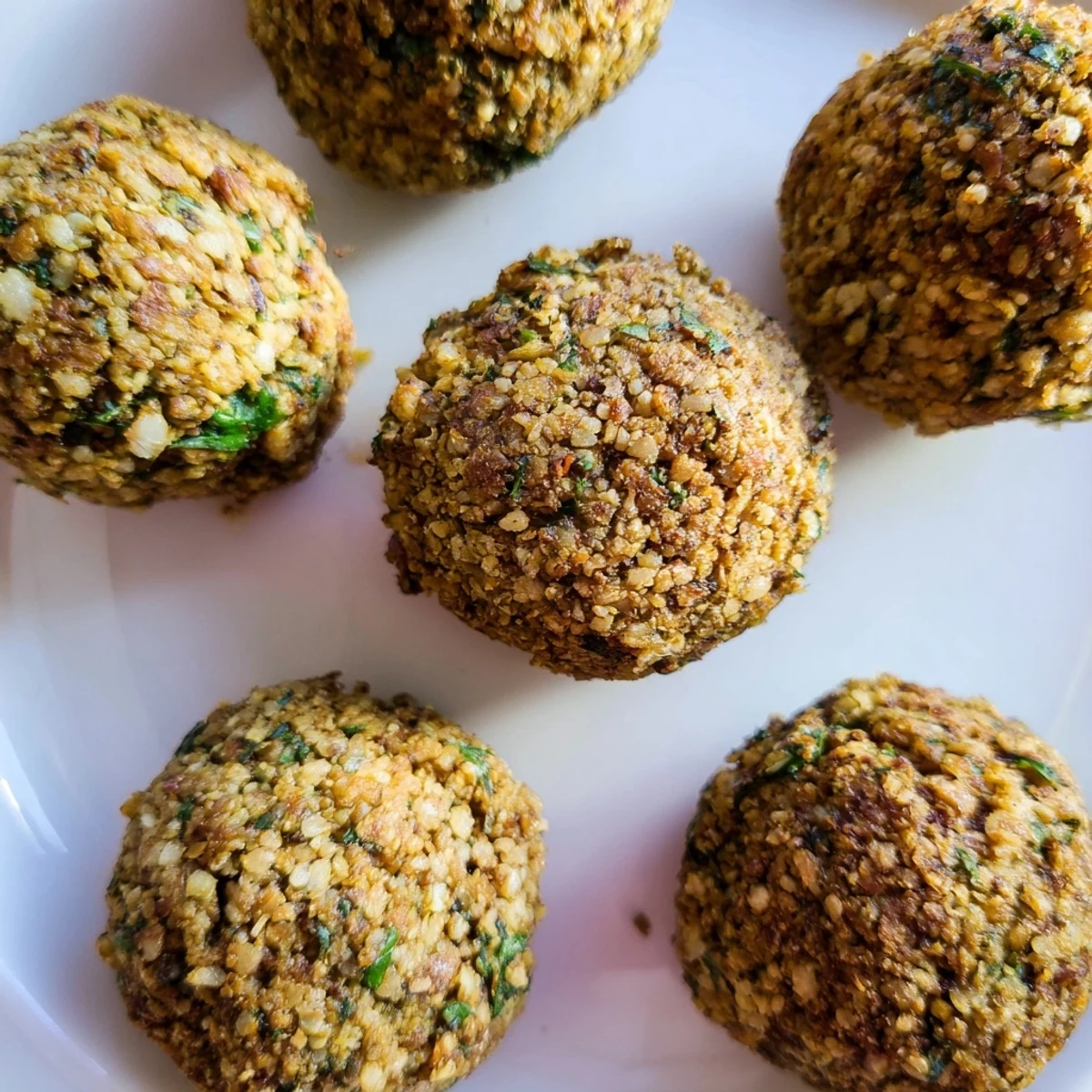 Close-up of flavorful, fried Levantine falafel balls, showcasing their perfectly textured, delicious exterior.