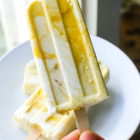 Creamy Mango Yogurt Banana Breakfast Pops, a vibrant swirl of fruit and yogurt, freezing solid.