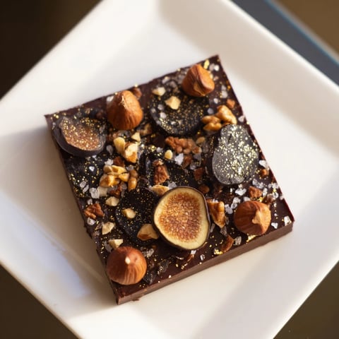 Rich Midnight Mosaic dessert showcasing dark chocolate, figs, and olives, a visually stunning treat.