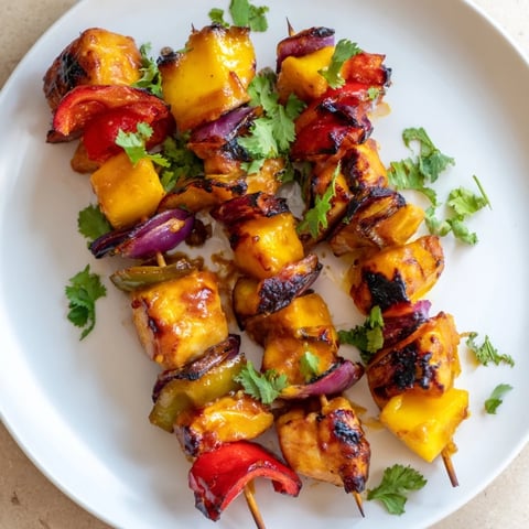 Juicy Mango Lime Chicken Skewers, grilled to perfection, with colorful peppers and onions, ready to be enjoyed.