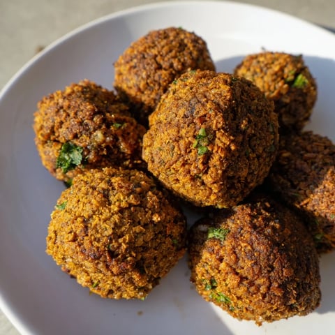 Golden-brown, crispy Levantine falafel balls ready to be enjoyed with tahini sauce and pita bread.