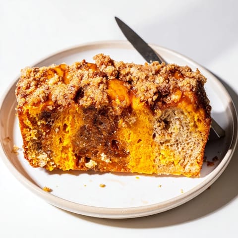 Warm slices of Cinnamon Sugar Pumpkin Pancake Loaf drizzled with maple syrup for brunch.  