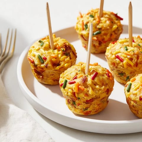 Deliciously crunchy Chili Garlic Funfetti Muffin Pops served on lollipop sticks for snacks.  