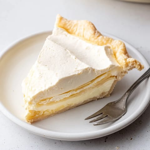 Homemade water pie showcasing creamy custard filling and buttery, flaky crust slices.  