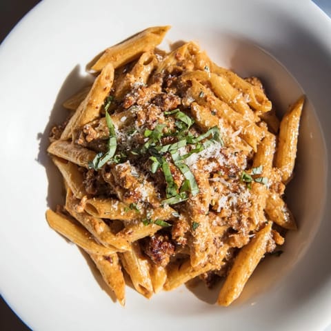 Sizzling Italian sausage blended with creamy tomato sauce atop the delicious pasta dish.