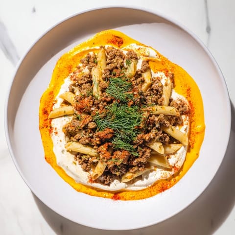 A comforting bowl of Turkish Pasta with Ground Turkey, creamy yogurt, and browned, spiced meat.