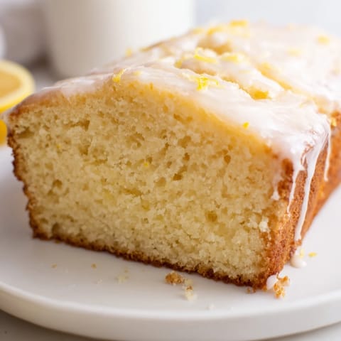 A slice of lemon yogurt cake, showing off a delightful, moist texture and bright aroma.