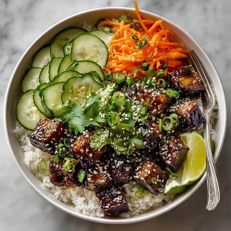 Close-up of colorful miso ginger glazed eggplant bowls, featuring tender eggplant and crunchy vegetables with sesame seeds.