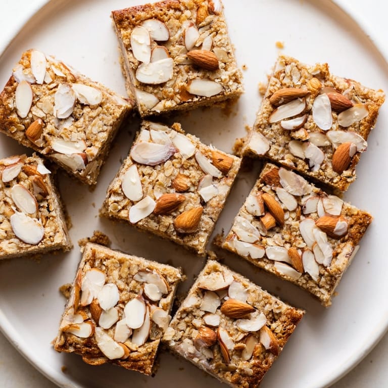 Bite-sized healthy Protein Cinnamon Almond Squares, plated for a protein-packed breakfast or snack.