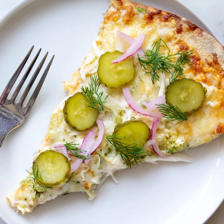 Deliciously unique Pickle Pizza topped with melted mozzarella and crunchy pickles.  