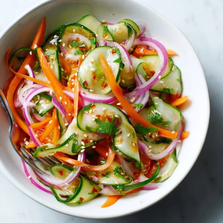 Bright and refreshing cucumber salad remix topped with toasted sesame seeds for crunch.