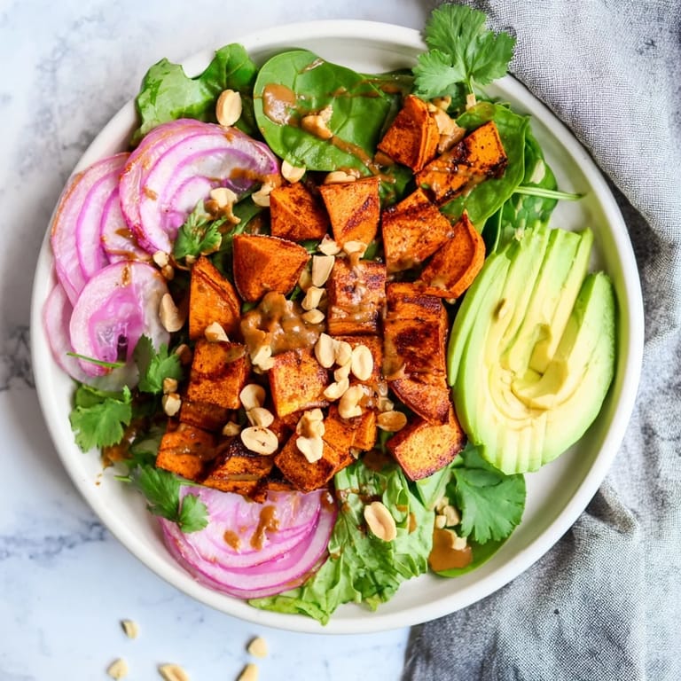 Delicious Spiced Peanut Sweet Potato & Radicchio Salad Bowl, with colorful ingredients like radicchio and avocado.
