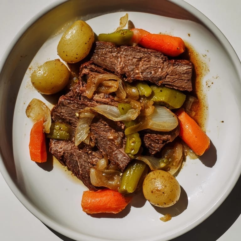 Close-up image shows the flavorful pickle brine pot roast with glistening, juicy meat and vibrant carrots.