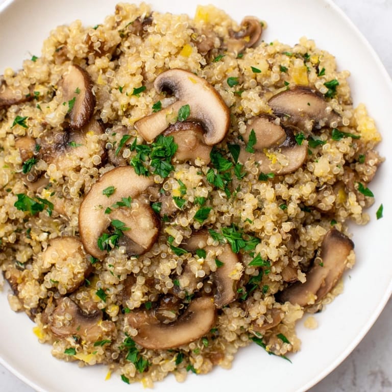 Savory Mushroom Quinoa Risotto, a healthy, gluten-free, Italian-inspired recipe, garnished beautifully.