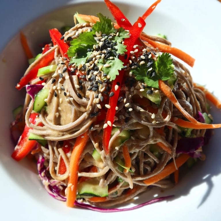 Close-up photo of delicious soba noodle salad, showcasing fresh ingredients and a zesty dressing.