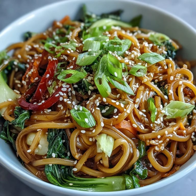 Healthy low-carb vegan meal served warm, with colorful carrot ribbons and bright green bok choy.