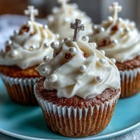 Adorable mini cupcakes with smooth vanilla frosting and fondant rosary toppers, ideal for First Communion celebrations.